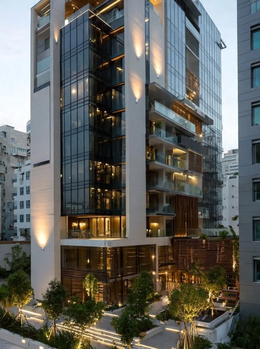 High-rise tower at dusk, fully glazed and lit